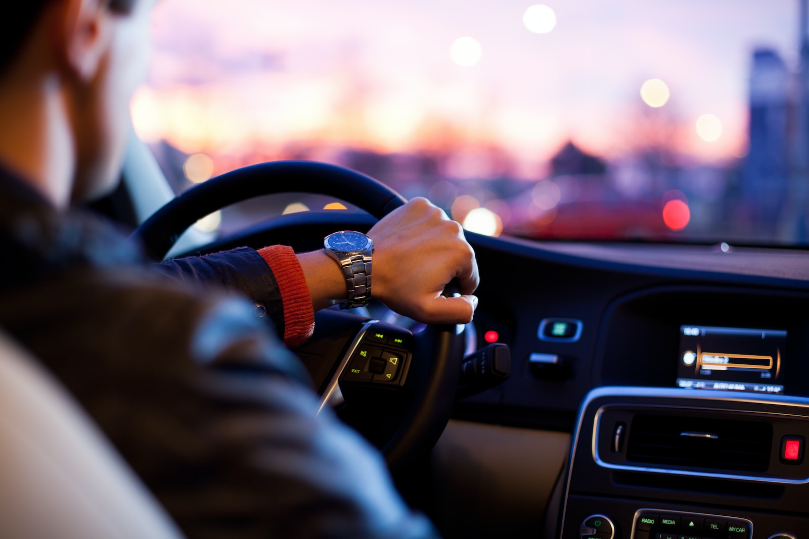 man driving a car wearing wrist watch, auto insurance